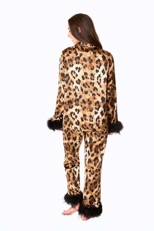 Young girl in a leopard print pajama set with black feather trim on the cuffs and ankles, wearing a pink glitter headband. - Image 27