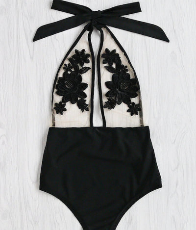 Black one-piece bikini with halter neck, sheer mesh top, and intricate black floral applique details. - Image 7