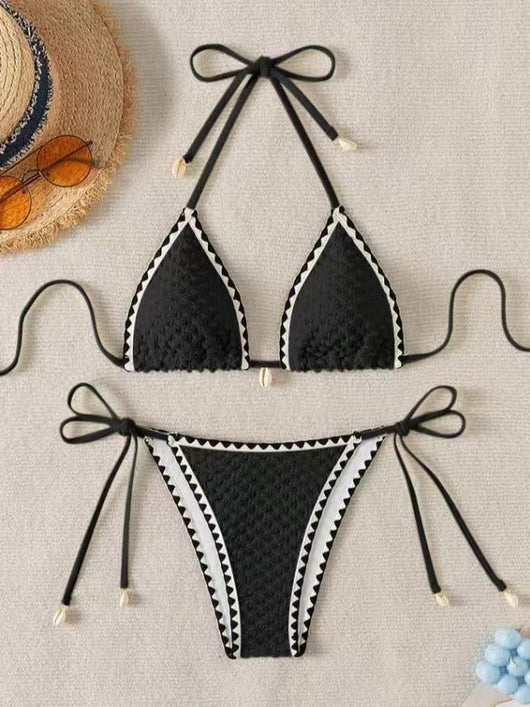 Black textured bikini with white scalloped trim, halter top, and tie-side bottoms featuring small shell details. - Image 11