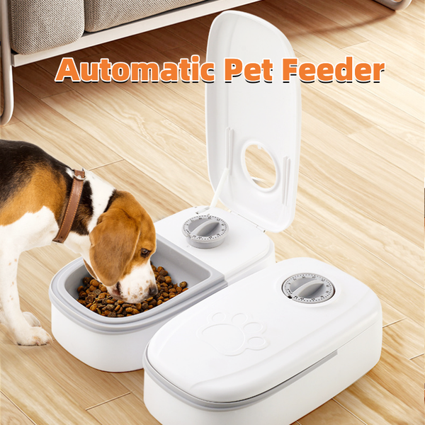 White automatic pet feeder with a pink timer dial and an embossed paw print on the lid.