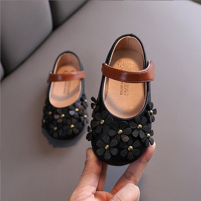 Black Mary Jane shoes for girls with 3D flower appliques on the toe and a brown hook-and-loop strap. - Image 3