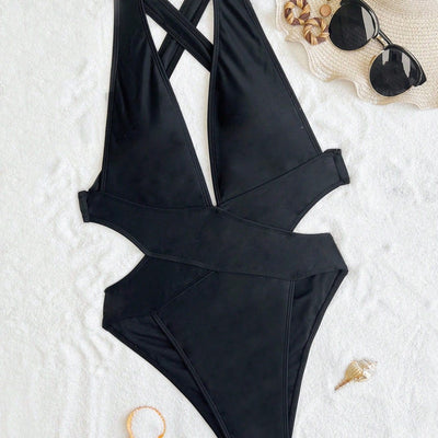 Woman in a black one-piece swimsuit with a deep V-neck and criss-cross waist cutouts, wearing a straw hat. - Image 4