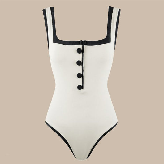 Woman in a white one-piece swimsuit with black trim and decorative buttons, sitting on a boat. - Image 3