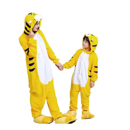 Young child in a yellow tiger hooded flannel pajama jumpsuit with white belly and black stripes, standing indoors. - Image 2