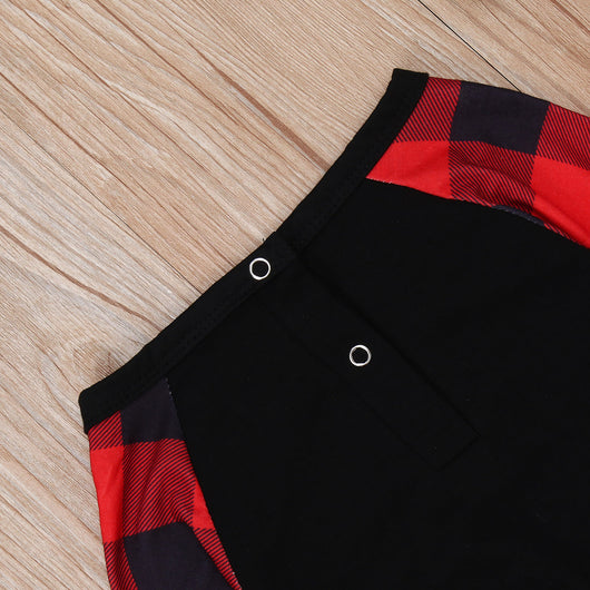 Family matching Christmas pajamas with black tops, red plaid sleeves, and Santa wearing a mask, paired with red plaid pants. - Image 13