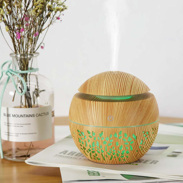 Dark wood grain mini ultrasonic humidifier with a mushroom shape and decorative hollow-out pattern.