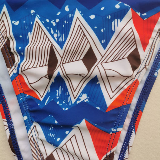 Red, white, and blue geometric print bikini with a triangle top and high-waisted, high-cut bottom. - Image 9