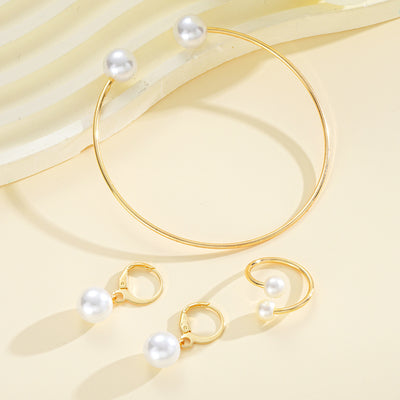 Gold-tone open cuff bracelet, matching open ring, and dangle earrings, all featuring white faux pearls. - Image 7