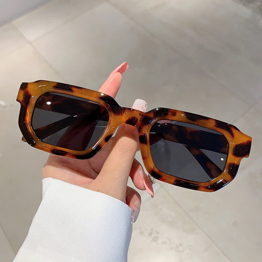 Black square-frame sunglasses with thick, angular frames and dark blue lenses, shown on a white background. - Image 4