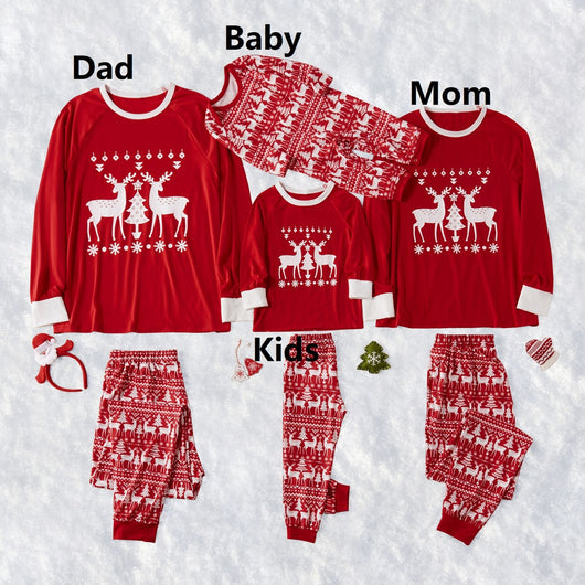 Family of four wearing matching red Christmas pajamas with white reindeer and tree patterns, standing by a decorated tree. - Image 8