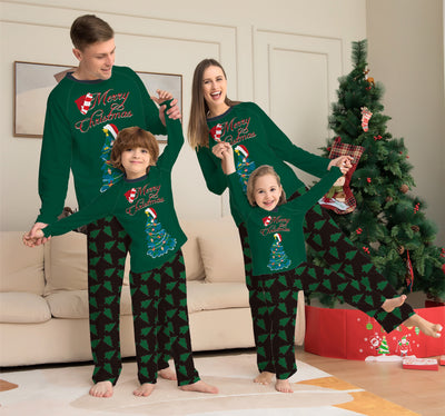 Family of four wearing matching green Christmas pajamas with "Merry Christmas" text and tree graphics. - Image 6