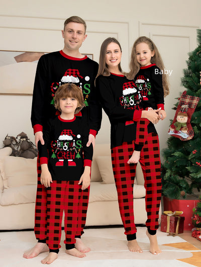Man wearing black and red plaid Christmas pajamas with a Santa graphic top and matching pants. - Image 19