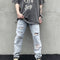 Distressed Slim Fit Jeans with Strategic Rips and Ink Effect