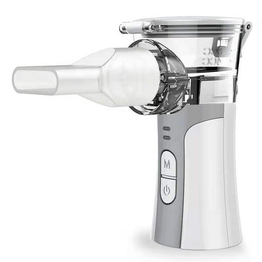 Hand-held compression atomizer with a clear mask and white and blue body, emitting a fine mist. - Image 2