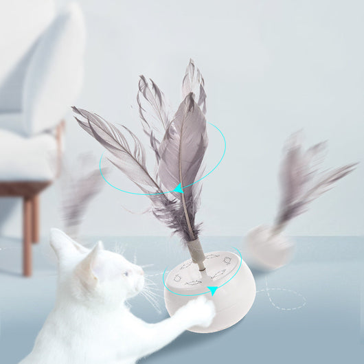 White pet tumbler cat toy with grey feathers on top and fish patterns on the spherical base. - Image 6