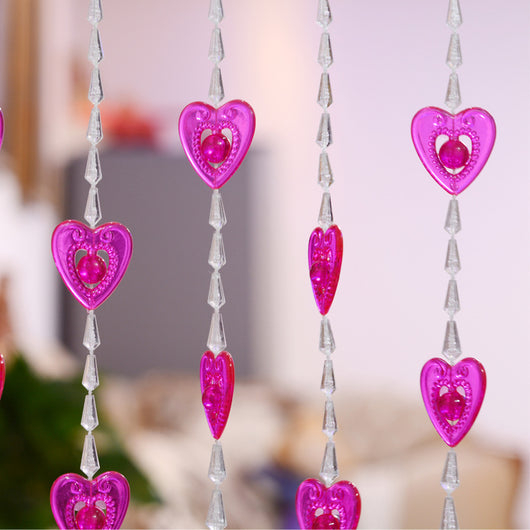Close-up of a decorative door curtain with alternating red heart-shaped beads and clear faceted acrylic beads. - Image 8