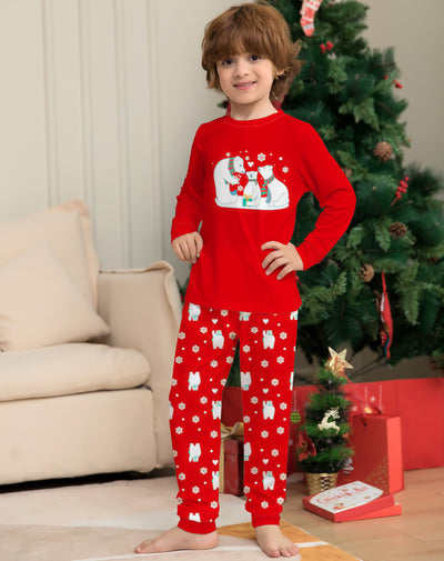 Young child wearing a red two-piece pajama set with a polar bear family graphic and snowflake print. - Image 6