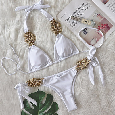 White two-piece bikini with gold braided knot details on the halter straps and tie-side bottom, laid flat. - Image 5