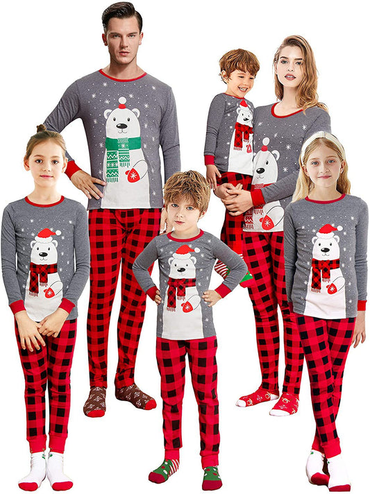 Family of five wearing matching gray and red buffalo plaid Christmas pajamas with polar bear print.
