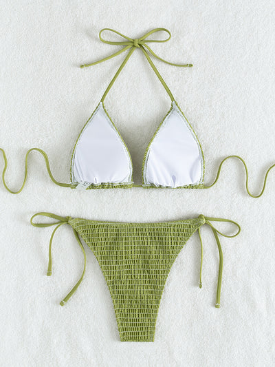 Women's lime green halter bikini with spaghetti straps and thong bottom, modeled outdoors against a blue sky. - Image 33