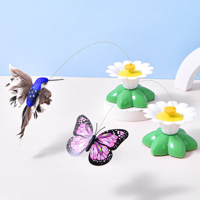 Automatic cat teaser toy with an electric rotating bird on a steel wire, attached to a green and white flower base.