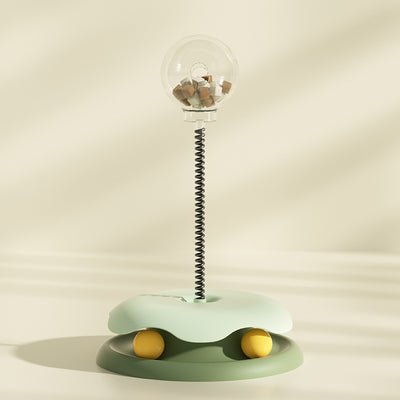 Mint green and dark green cat leakage food toy with a clear spherical treat dispenser on a black spring. - Image 10