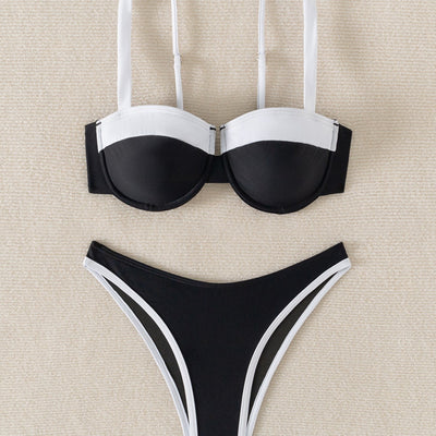 Black and white color block bikini with underwire top and high-cut bottoms, modeled by a woman by a pool. - Image 4