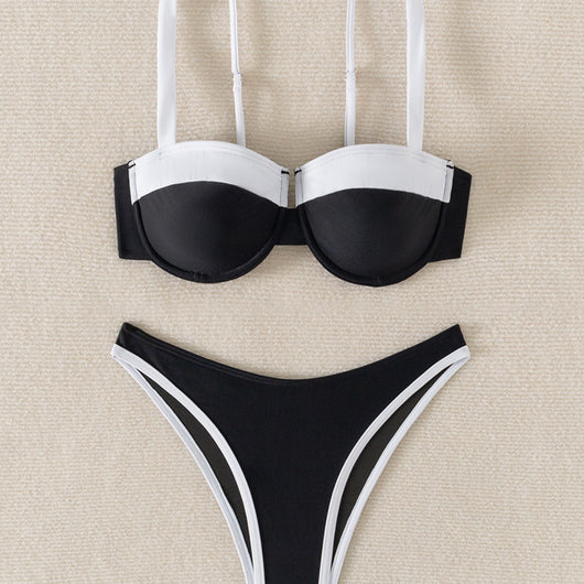 Black and white color block bikini with underwire top and high-cut bottoms, modeled by a woman by a pool. - Image 4