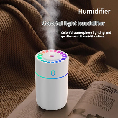 Pink cylindrical humidifier with a colorful LED light ring on top and a blue-green light band around its middle. - Image 2