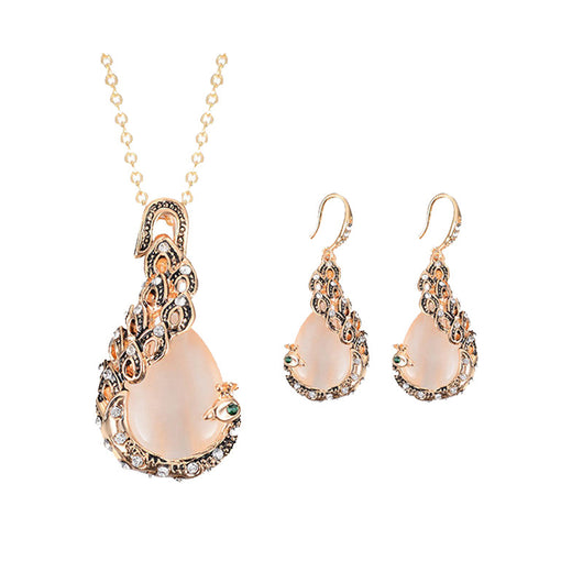 Rose gold tone bridal jewelry set with a necklace and stud earrings, each featuring a large blue teardrop gem and clear accents. - Image 3