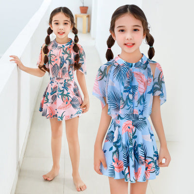 Mother and daughter matching swimsuits with blue and pink tropical leaf print. Adult halter top and skirt, child's ruffle top and skirt. - Image 9