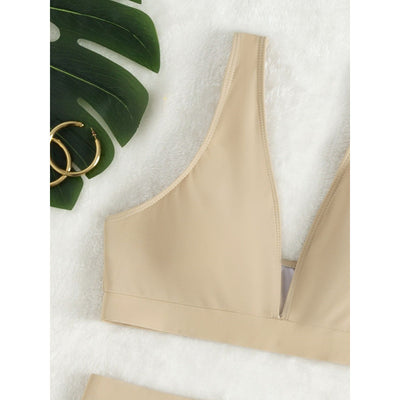 Women's deep-V Halong Bay-style two-piece swimsuit in light beige, featuring a crop top and high-waisted shorts. - Image 3
