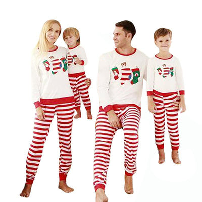 Father and son wearing matching Christmas pajamas with white long-sleeved tops featuring stocking prints and red and white striped pants. - Image 11