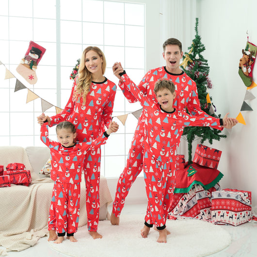 Family of four wearing matching green Christmas pajamas with snowman and Christmas tree print, red trim. - Image 11