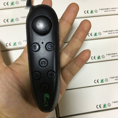 White Bluetooth remote control gamepad with joystick and multiple buttons, held in a hand. - Image 5