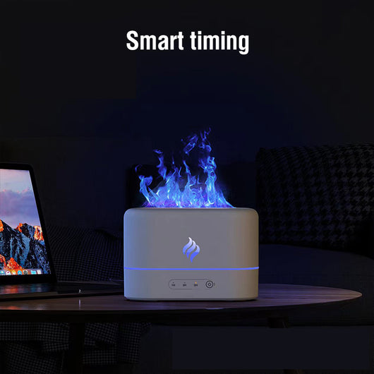 White simulated flame humidifier with blue light effect and yellow flame icon, sitting on a white table. - Image 10