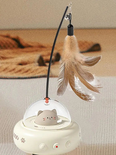 Electric interactive cat toy with a beige base, clear dome, and a cute cat head inside. Features a feather teaser wand with a bell. - Image 19