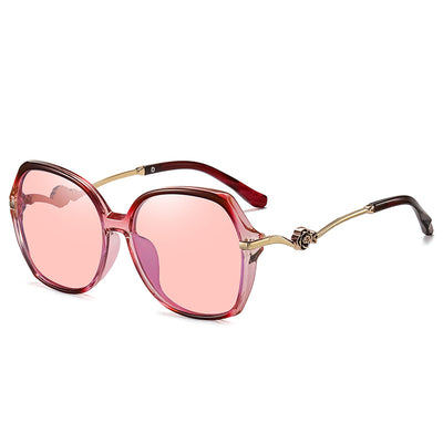 Oversized round-frame sunglasses with pink polarized lenses, translucent pink and brown frame, and gold floral temple accents. - Image 10