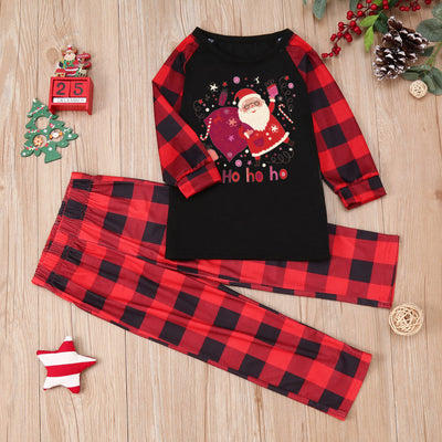 Family matching Christmas pajamas with black tops featuring a Santa graphic and red buffalo plaid sleeves and pants. - Image 6