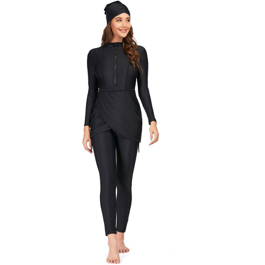 Woman wearing a black conservative Muslim swimsuit with a long-sleeved top, draped peplum, leggings, and swim turban. - Image 3