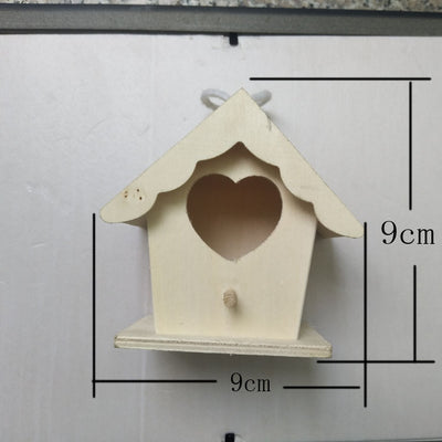Unfinished wooden birdhouse with a circular entrance hole and a small perch, held by a hand. - Image 4