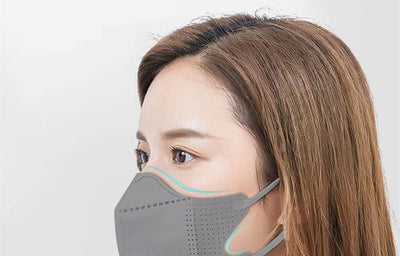 Peach disposable 3-layer face mask with perforated details worn by a person, offering comfortable daily protection. - Image 22