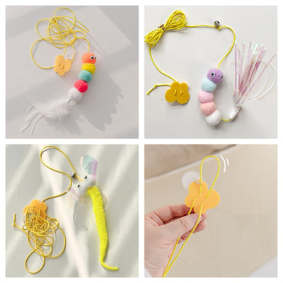 Colorful cat toy with pom-poms, googly eyes, white feathers, and a yellow elastic rope with a suction cup. - Image 2