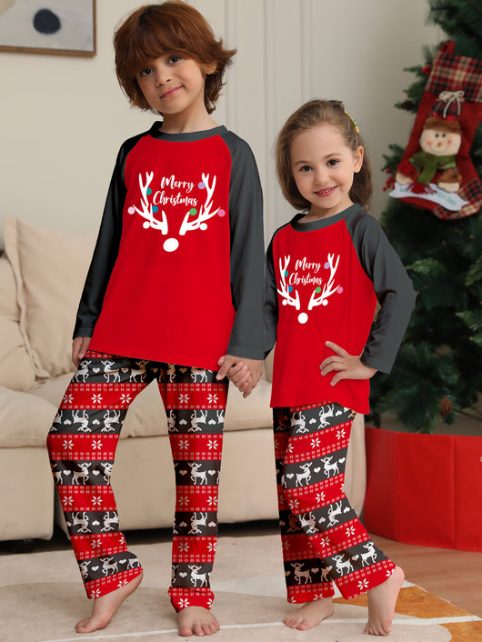 Family of four wearing matching red and black Christmas pajamas with a deer head and "Merry Christmas" print. - Image 11