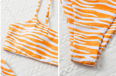 Tan and white zebra stripe two-piece bikini with a bandeau top and high-cut bottom, laid flat. - Image 25