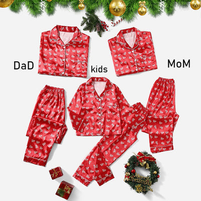 Three dark blue family pajama sets with white and light blue snowflake patterns, featuring long-sleeve tops and pants. - Image 2