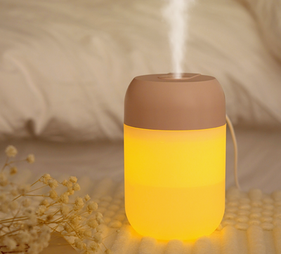 White cylindrical mini humidifier with a soft yellow glow, suitable for air moisturizing and aromatherapy, USB powered. - Image 13