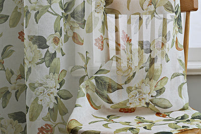 Dark gray semi-sheer curtains with a white and green floral pattern, hung on a black rod in a living room. - Image 13