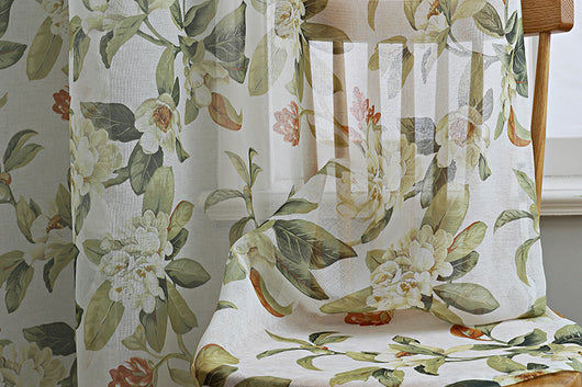 Dark gray semi-sheer curtains with a white and green floral pattern, hung on a black rod in a living room. - Image 13