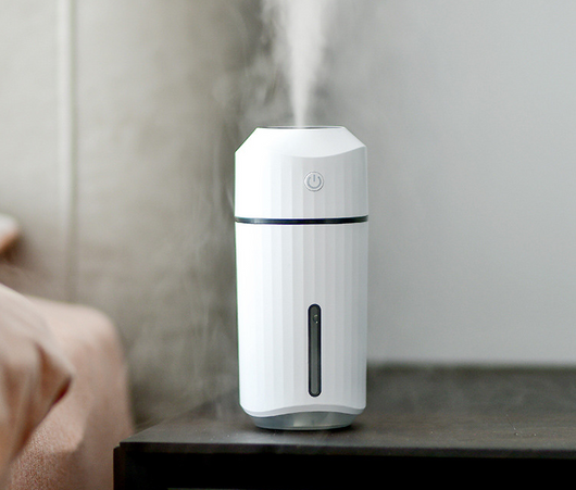 Pink columnar mini car humidifier with a power button and a clear water level indicator on a white background. - Image 17